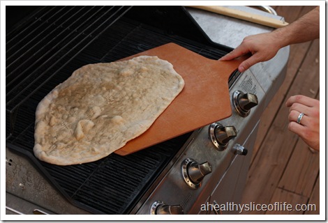 flipping pizza dough on grill