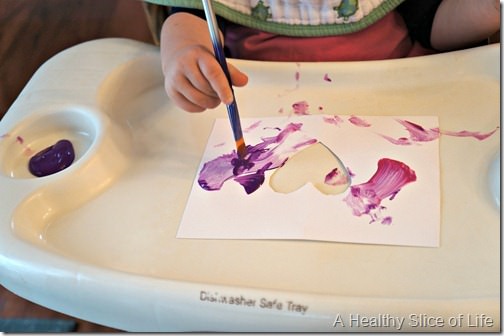 toddler valentine art- painting in high chair