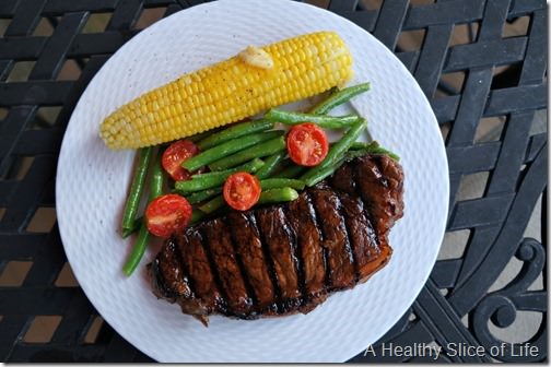 summer steak dinner with green beans and corn