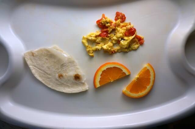baby led weaning meals- scrambled eggs with tomatoes, orange and a tortilla