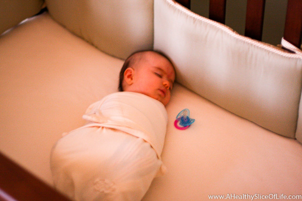 baby swaddled in crib